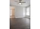 Spacious bedroom featuring dark wood floors, ceiling fan, and two windows for natural light at 728 Morningside Dr, Mount Holly, NC 28120
