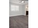 Spacious bedroom featuring dark wood floors and a large window for natural light at 728 Morningside Dr, Mount Holly, NC 28120