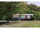 Charming single-story home with mature trees and a well-maintained front yard at 728 Morningside Dr, Mount Holly, NC 28120
