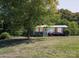 Charming single-story home with mature trees and a well-maintained front yard at 728 Morningside Dr, Mount Holly, NC 28120
