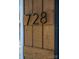 Close up of 728 house number affixed to stylish wood plank at 728 Morningside Dr, Mount Holly, NC 28120