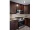 Kitchen featuring stainless steel appliances and dark cabinetry at 728 Morningside Dr, Mount Holly, NC 28120