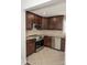 A modern kitchen featuring stainless steel appliances, granite countertops and tile flooring at 728 Morningside Dr, Mount Holly, NC 28120