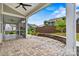 Backyard patio with stone retaining wall, view of the screened porch, and well-maintained lawn at 7362 Overjoyed Xing, Charlotte, NC 28215