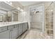 Bathroom featuring tile floors, double vanity, and a tiled walk-in shower with bench at 7362 Overjoyed Xing, Charlotte, NC 28215
