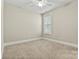 Cozy bedroom with neutral carpet, trim, and a window with natural light at 7362 Overjoyed Xing, Charlotte, NC 28215
