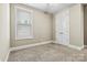 Simple bedroom featuring carpeted floors and a window for natural light at 7362 Overjoyed Xing, Charlotte, NC 28215