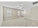 Well-lit carpeted bonus room featuring three windows with blinds and neutral color palette at 7362 Overjoyed Xing, Charlotte, NC 28215
