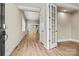 Entryway of home features hardwood flooring leading into an open floor plan with white trim and doors at 7362 Overjoyed Xing, Charlotte, NC 28215