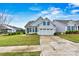 Inviting single-Gathering home featuring a well-manicured lawn and a two-car garage with a concrete driveway at 7362 Overjoyed Xing, Charlotte, NC 28215