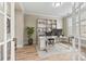Bright home office with white desk, hardwood flooring, and modern shelving, ideal for remote work at 7362 Overjoyed Xing, Charlotte, NC 28215