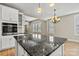 The kitchen island is the focal point, complimented by granite countertops and ample storage space at 7362 Overjoyed Xing, Charlotte, NC 28215