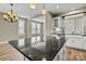 Kitchen island features a granite countertop, modern lighting, and stainless steel appliances at 7362 Overjoyed Xing, Charlotte, NC 28215