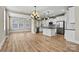 Bright, open kitchen featuring white cabinets, stainless steel appliances, and a large island at 7362 Overjoyed Xing, Charlotte, NC 28215
