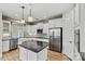This well-lit kitchen has stainless appliances, granite counters, and an island at 7362 Overjoyed Xing, Charlotte, NC 28215