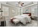 Bedroom featuring a trey ceiling, ceiling fan, carpet floors, and multiple windows letting in natural light at 7362 Overjoyed Xing, Charlotte, NC 28215
