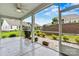 Inviting screened porch with a view of the landscaped backyard and neighboring houses at 7362 Overjoyed Xing, Charlotte, NC 28215