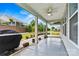A view of the backyard from the screened-in porch, featuring a grill and brick patio at 7362 Overjoyed Xing, Charlotte, NC 28215