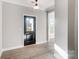 Inviting entryway features light wood floors and a black front door with glass panel at 7513 Lancaster Hwy # 6, Waxhaw, NC 28173