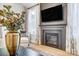 Cozy fireplace with a modern mantel, large TV, and bright, sheer curtains at 7513 Lancaster Hwy # 6, Waxhaw, NC 28173