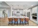 Bright kitchen with island seating, stainless steel appliances, and a view of the staircase at 7513 Lancaster Hwy # 6, Waxhaw, NC 28173