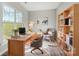 Bright home office with a large window, built-in bookshelf, and modern decor at 7513 Lancaster Hwy # 6, Waxhaw, NC 28173