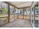 Enclosed porch featuring wood floors, railings, and views of the trees beyond at 7513 Lancaster Hwy # 6, Waxhaw, NC 28173