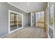 Enclosed porch featuring wood floors, gray walls, and sliding glass doors at 7513 Lancaster Hwy # 6, Waxhaw, NC 28173