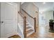 Elegant staircase with wood treads and white risers leads to upper level at 7513 Lancaster Hwy # 6, Waxhaw, NC 28173