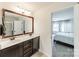 Bathroom featuring a double sink vanity with granite counters and a decorative mirror at 7650 W Berkeley Rd, Denver, NC 28037