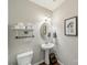 Small powder room features an oval mirror, pedestal sink, and a toilet at 7650 W Berkeley Rd, Denver, NC 28037