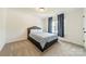 This is a bedroom with gray carpeting and a queen sized bed at 7650 W Berkeley Rd, Denver, NC 28037