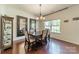An inviting dining area with a window boasts hardwood floors and tasteful decorative accents at 7650 W Berkeley Rd, Denver, NC 28037