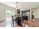 A dining room area with a dark wood table and chairs, plus access to the outdoor patio at 7650 W Berkeley Rd, Denver, NC 28037