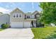 Charming two-story home featuring a two-car garage, brick accents, and a well-manicured lawn at 7650 W Berkeley Rd, Denver, NC 28037