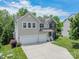Charming two-story home featuring a two-car garage, brick accents, and a well-manicured lawn at 7650 W Berkeley Rd, Denver, NC 28037