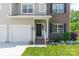 A charming home entrance showcasing a brick facade, manicured lawn, and inviting front porch at 7650 W Berkeley Rd, Denver, NC 28037