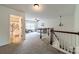 The loft features neutral colored carpet and a decorative chandelier at 7650 W Berkeley Rd, Denver, NC 28037