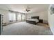 Main bedroom with large windows, gray curtains, and carpet at 7650 W Berkeley Rd, Denver, NC 28037