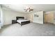 Spacious primary bedroom features neutral walls, soft carpet, and bright natural light at 7650 W Berkeley Rd, Denver, NC 28037