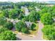 An aerial view of the property nestled in a neighborhood with mature trees and well-maintained lawns at 8339 Hornwood Ct, Charlotte, NC 28215