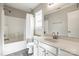This bathroom offers a shower and tub with a vanity and mirror at 8339 Hornwood Ct, Charlotte, NC 28215