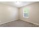 Cozy bedroom with neutral walls, carpet, and a window for natural light at 8339 Hornwood Ct, Charlotte, NC 28215