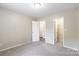 This bedroom offers neutral colors, carpet, and closet access for storage at 8339 Hornwood Ct, Charlotte, NC 28215