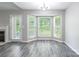 Sunlit dining area with bay windows overlooking landscaped backyard and modern light fixture at 8339 Hornwood Ct, Charlotte, NC 28215