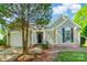 Charming home featuring attached garage, neutral siding, and manicured landscaping at 8339 Hornwood Ct, Charlotte, NC 28215