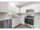 The kitchen boasts stainless steel appliances, white cabinets, and marble-look countertops at 8339 Hornwood Ct, Charlotte, NC 28215