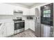 Kitchen featuring stainless steel appliances, including oven, microwave, and refrigerator, and white cabinets at 8339 Hornwood Ct, Charlotte, NC 28215
