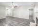 Open-concept living room featuring wood floors, neutral walls, and a glimpse into adjacent rooms at 8339 Hornwood Ct, Charlotte, NC 28215