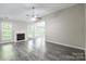 Spacious living room features a fireplace, vaulted ceiling and abundant natural light at 8339 Hornwood Ct, Charlotte, NC 28215